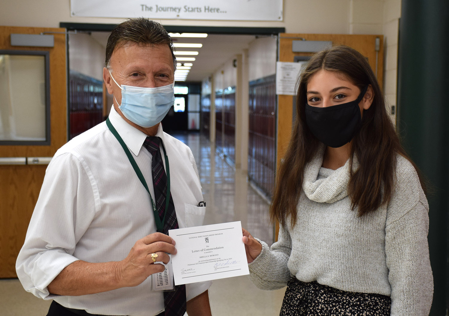 William Floyd High School Commended Student Ariella Morano is pictured with principal Philip Scotto receiving a National Merit Scholarship Program Commended Student Letter of Commendation.